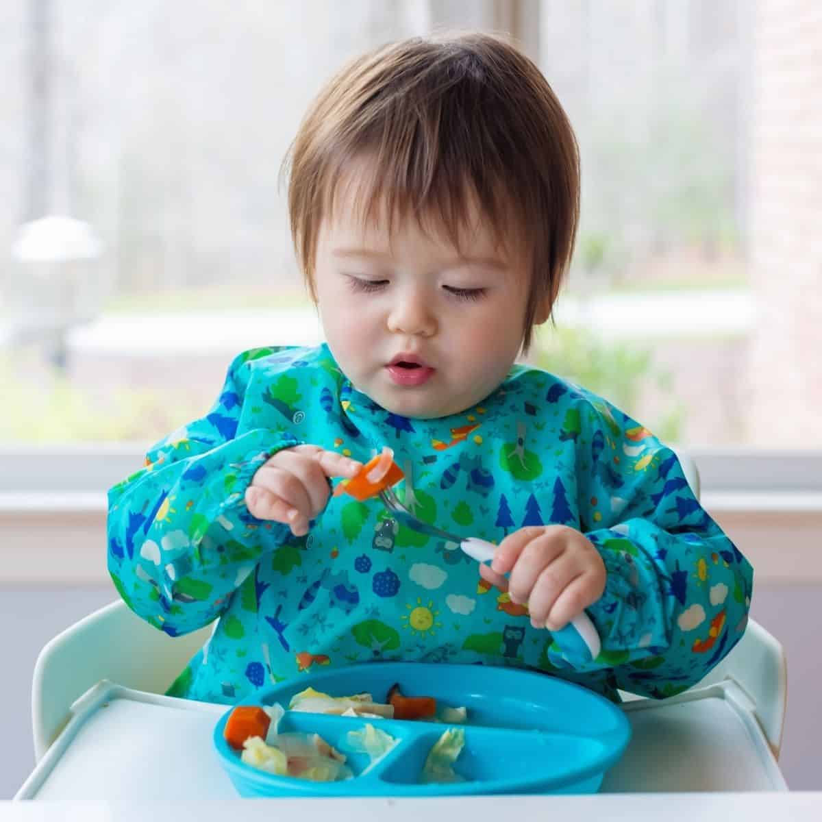 Children learning to feed themselves