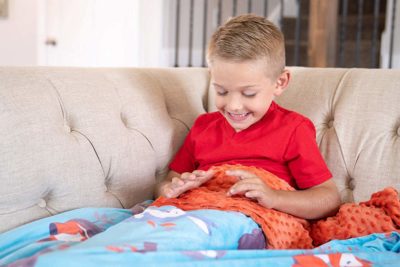 https://yourkidstable.com/wp-content/uploads/2018/11/sensory-toys-weighted-blanket-e1543348448251.jpg